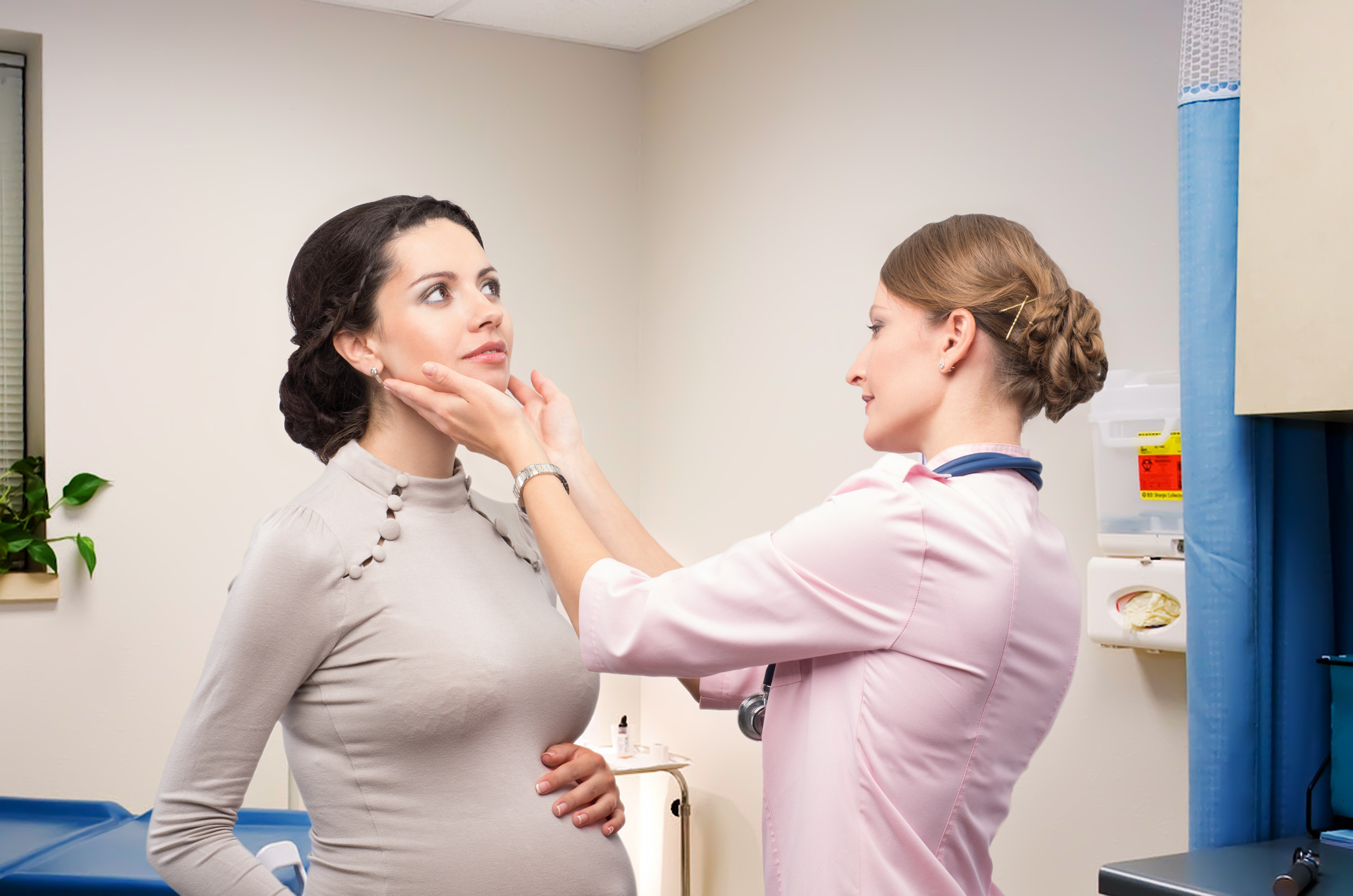 Pregnant woman getting her thyroid checked by a functional medicine doctor