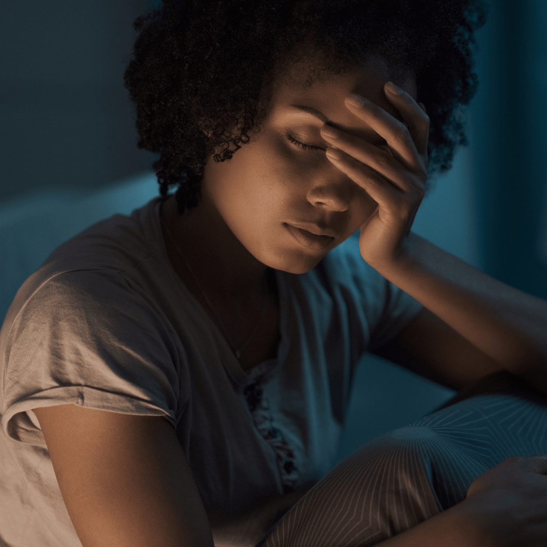 Woman suffering from a migraine during her period.