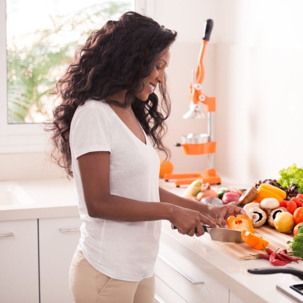 Woman preparing healthy food to support her menstrual cycle