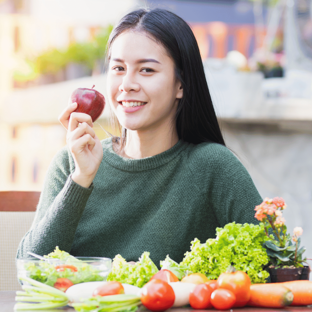 Woman enjoying food after figuring out her food sensitivities and healing her leaky gut.