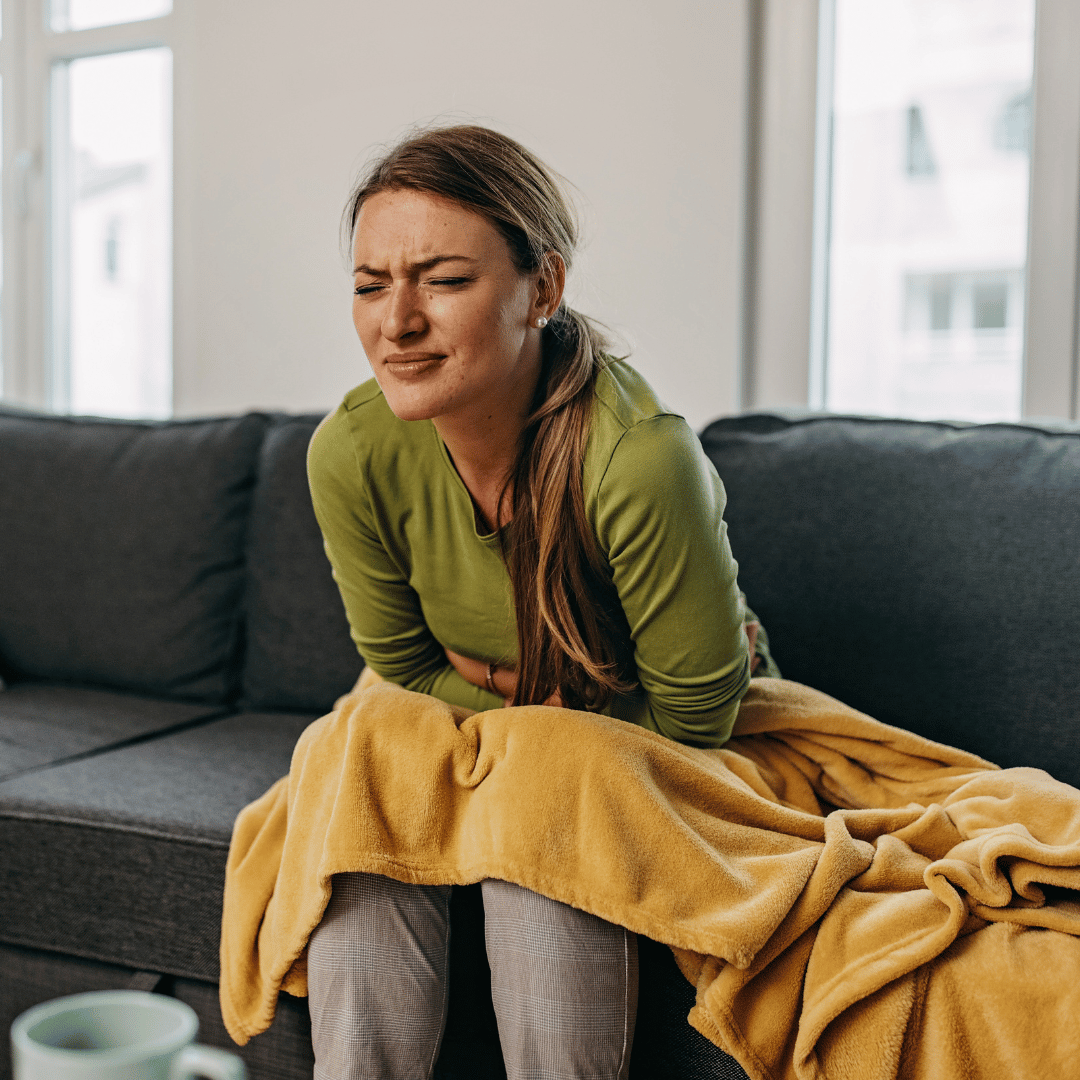 A woman suffering from stomach pain caused by a gut infection