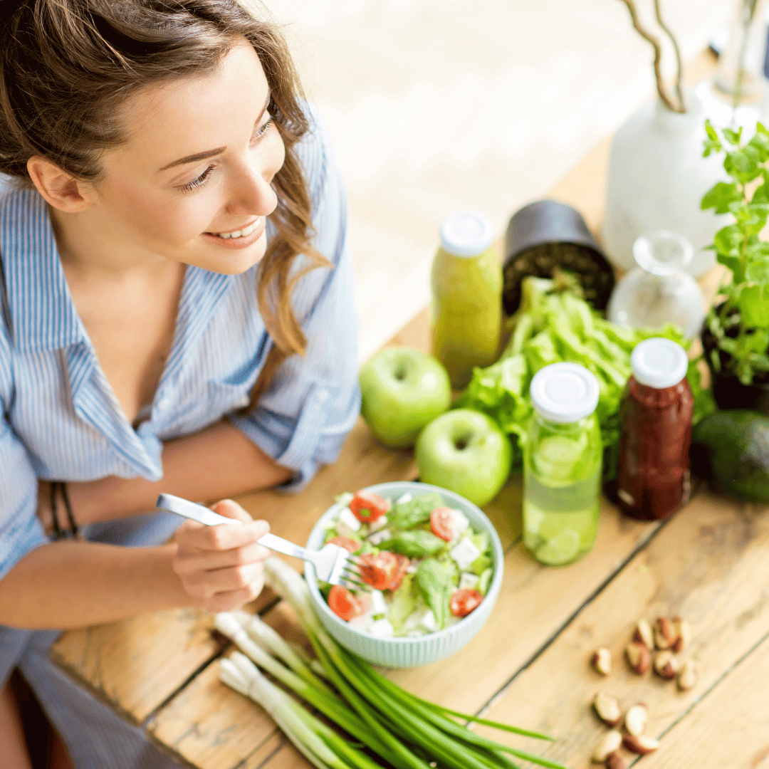 A woman eating healthy fiber rich foods to feed her beneficial got microbiome