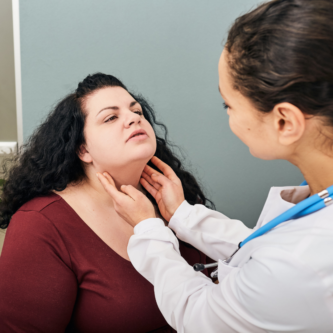 Woman having her thyroid examined and palpated by a functional medicine doctor